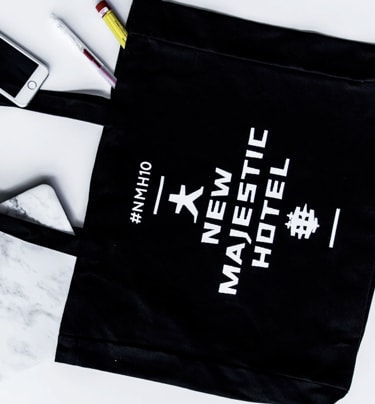 black canvas bag with New Majestic Hotel branding