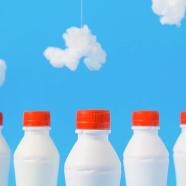 milk bottles with sky blue background with clouds