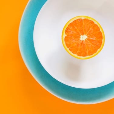 orange sliced in half on white plate