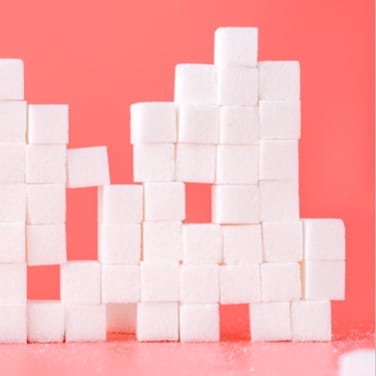 stacked sugar cubes with pink background